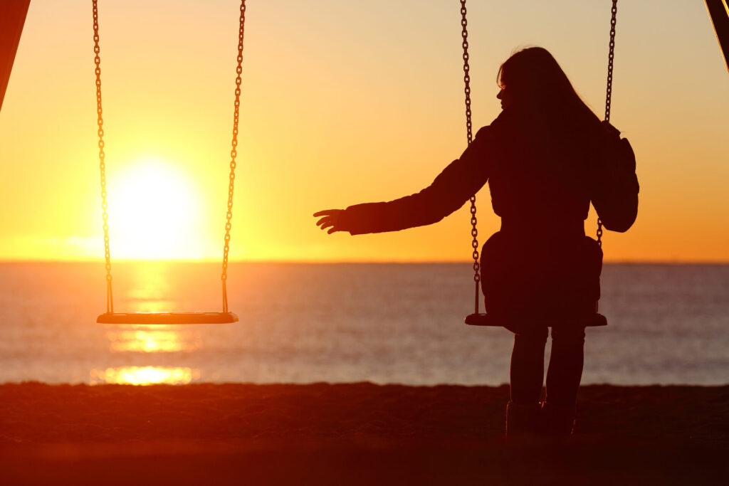 woman alone on a swing missing her partner