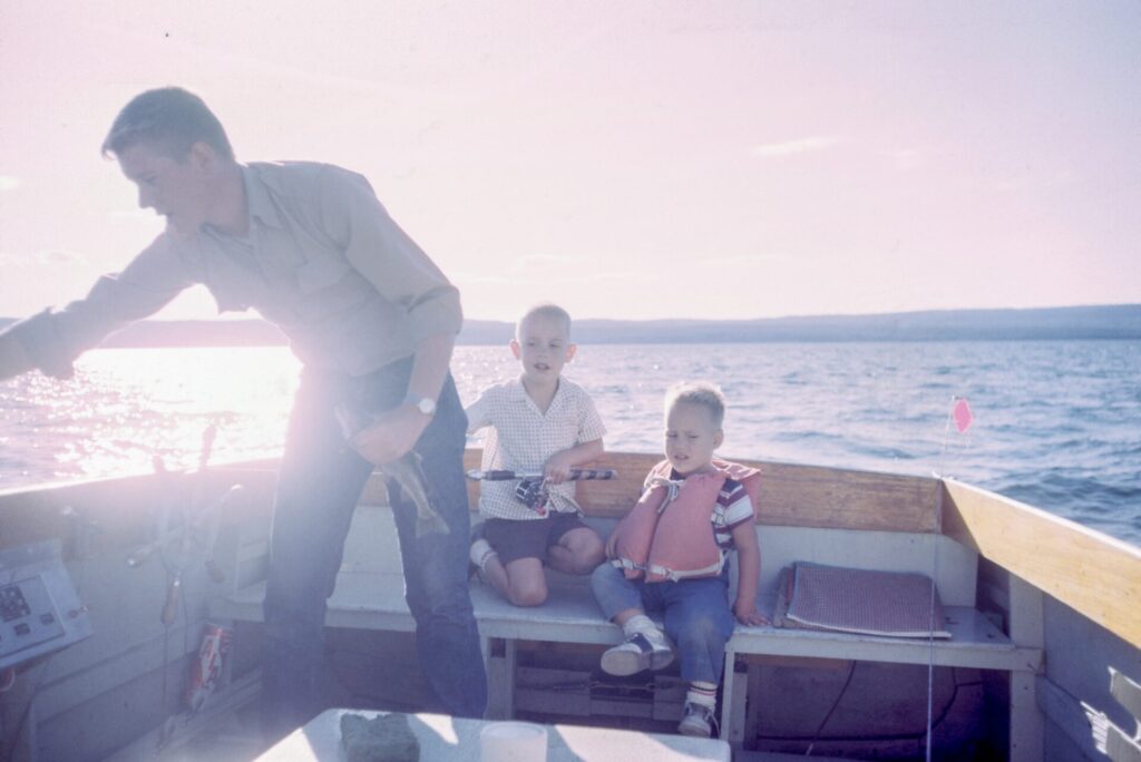 Dad fishing with his sons while on vacation